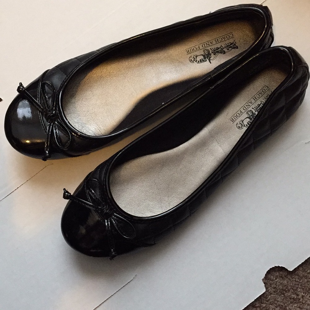 Coach and four black flats
